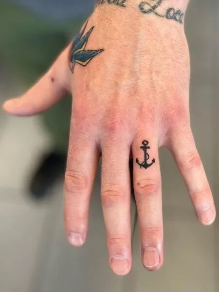 Anchor wedding ring tattoo